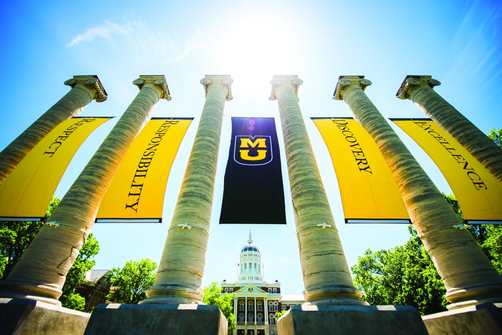 Image of the six Mizzou columns with banners hung in between depicting the core values of the university.