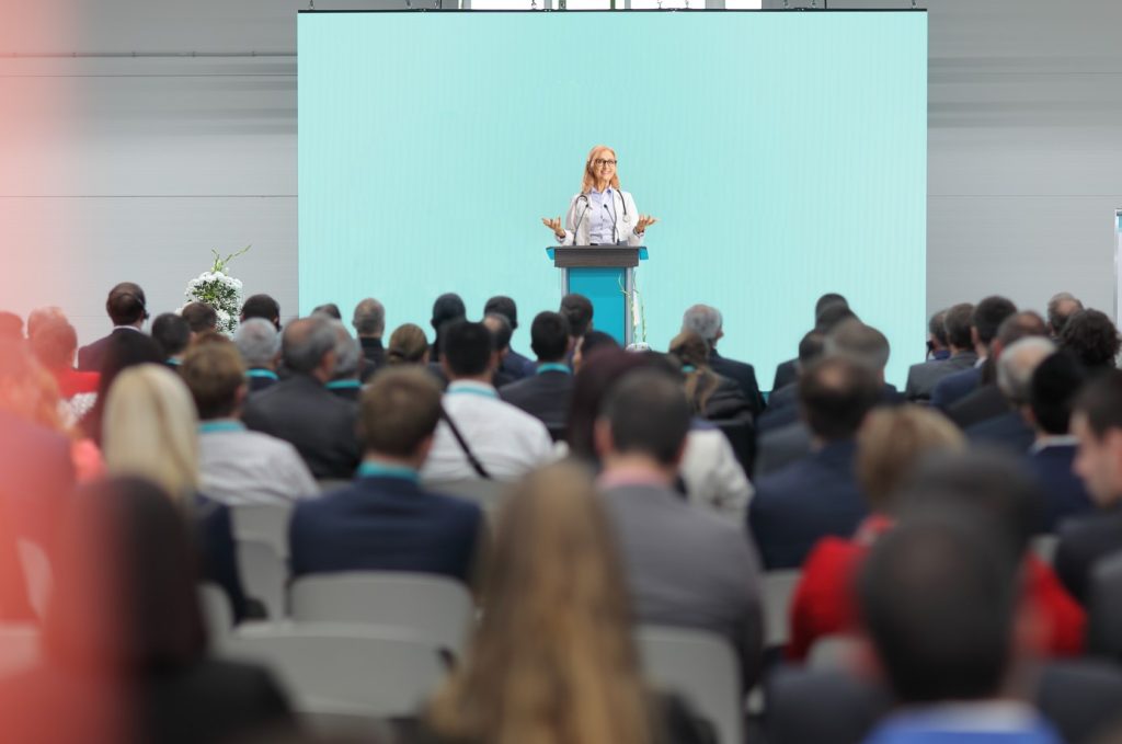 Image of doctor speaking to audience at a conference